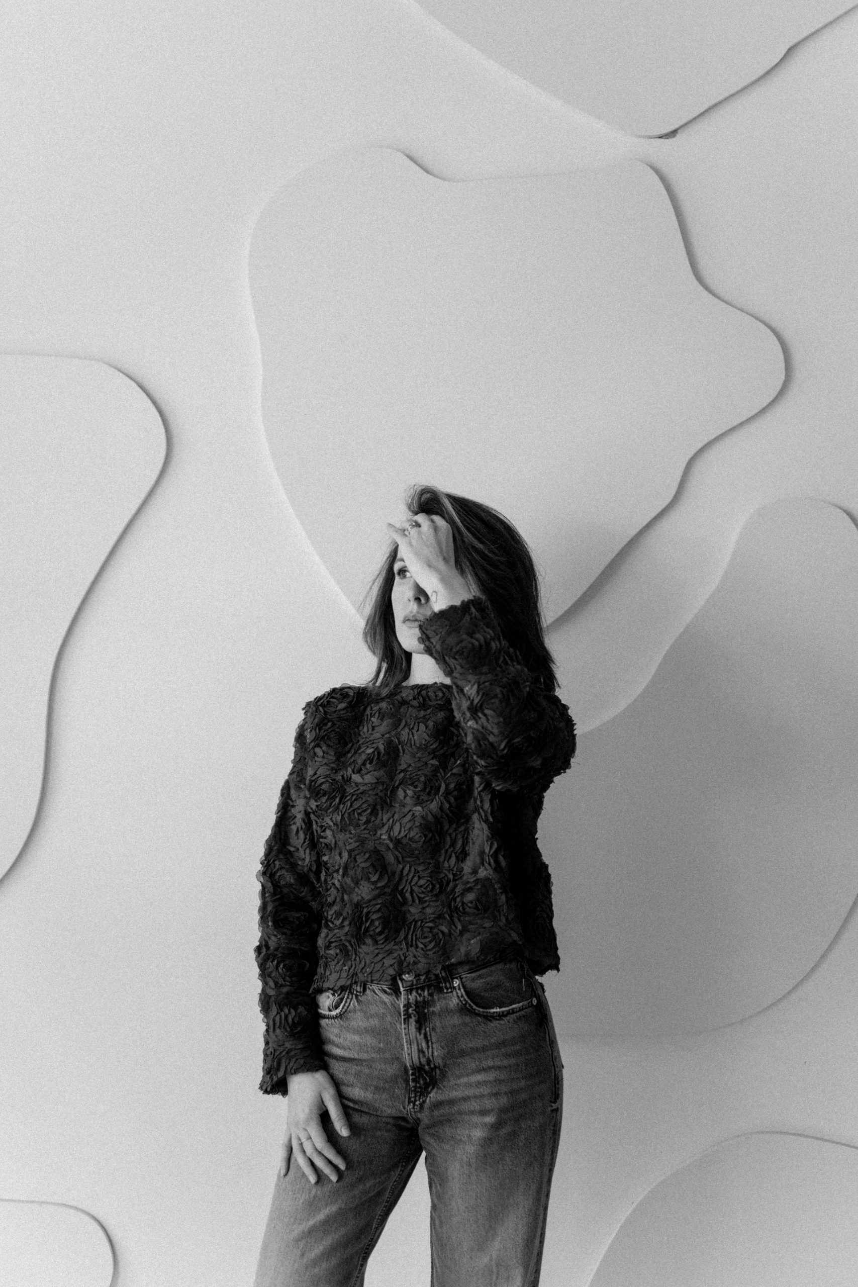 Ana in front of the studio wall