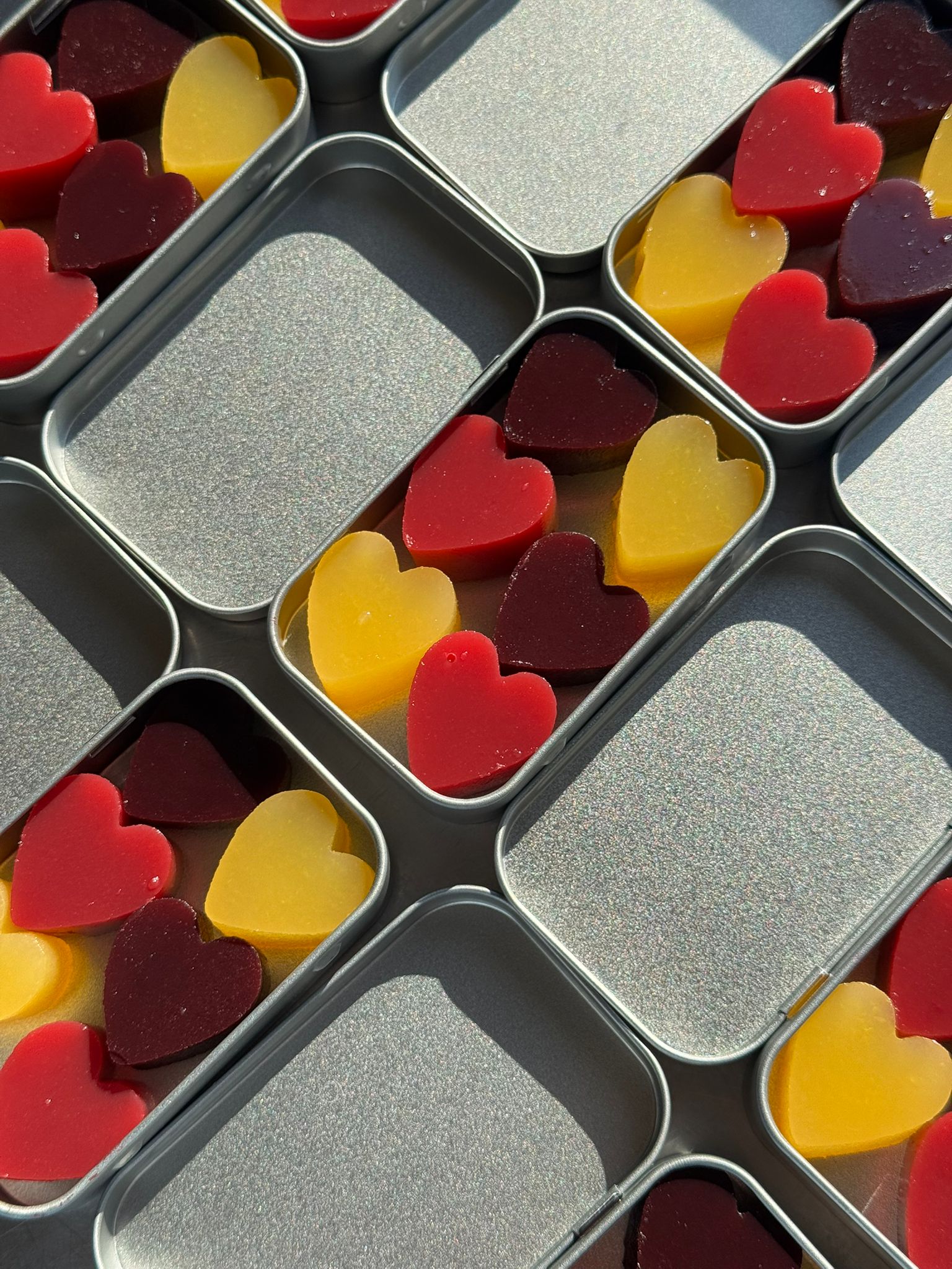 Open tins of heart jellies in the sun